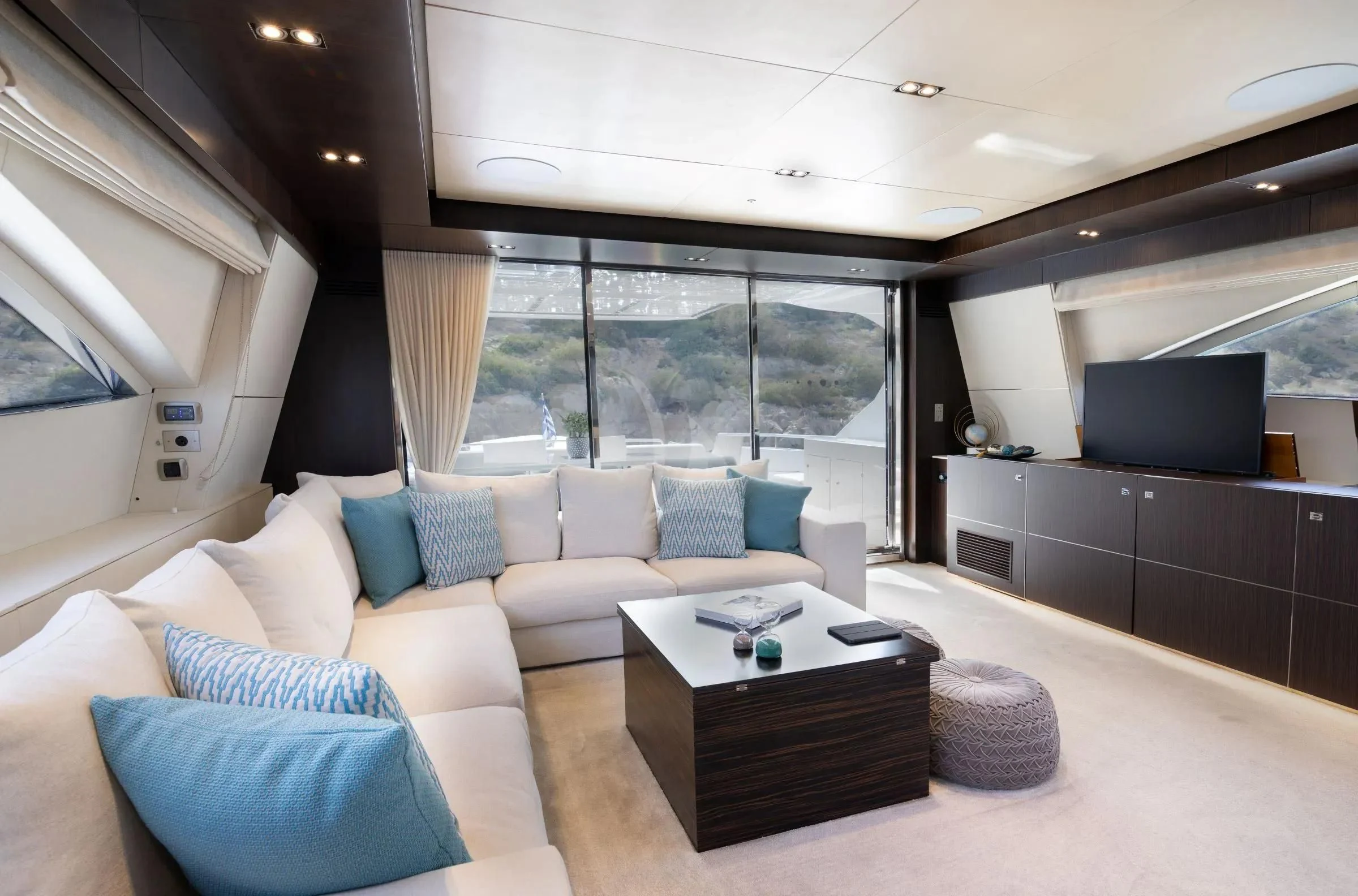 a living room with a large window aboard MAC Yacht for Sale