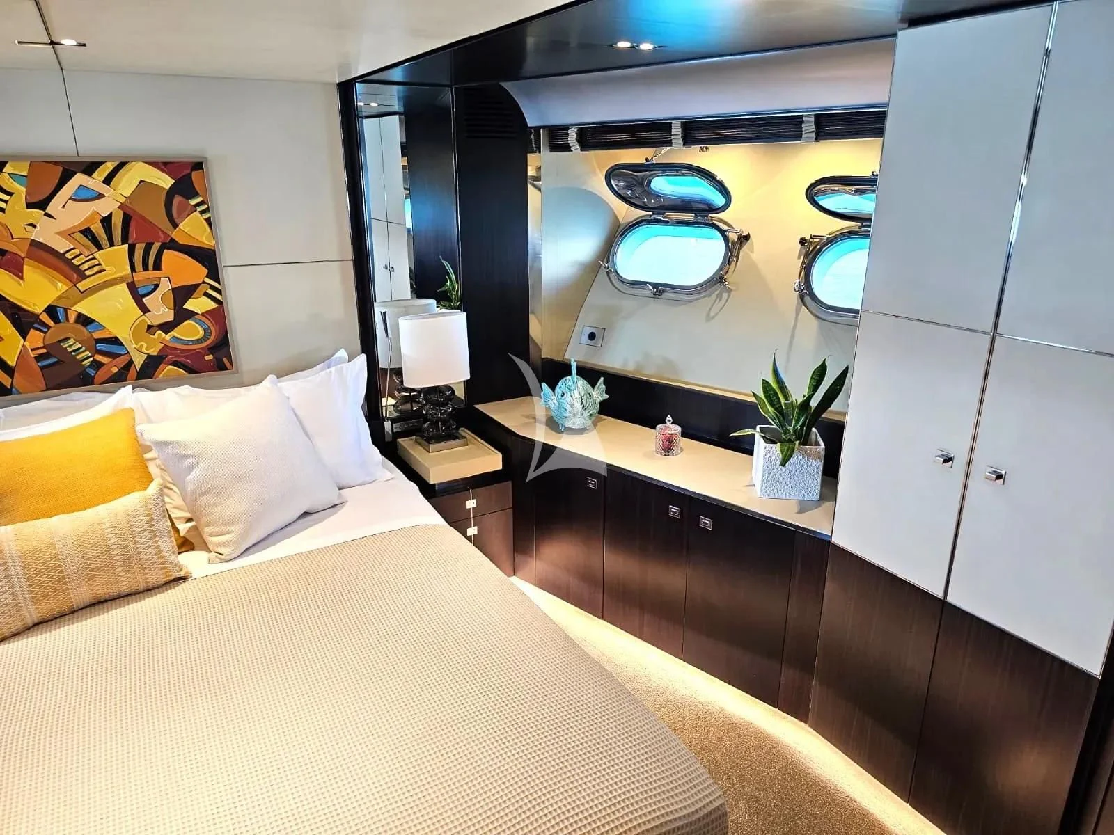 a bedroom with a large mirror aboard MAC Yacht for Sale