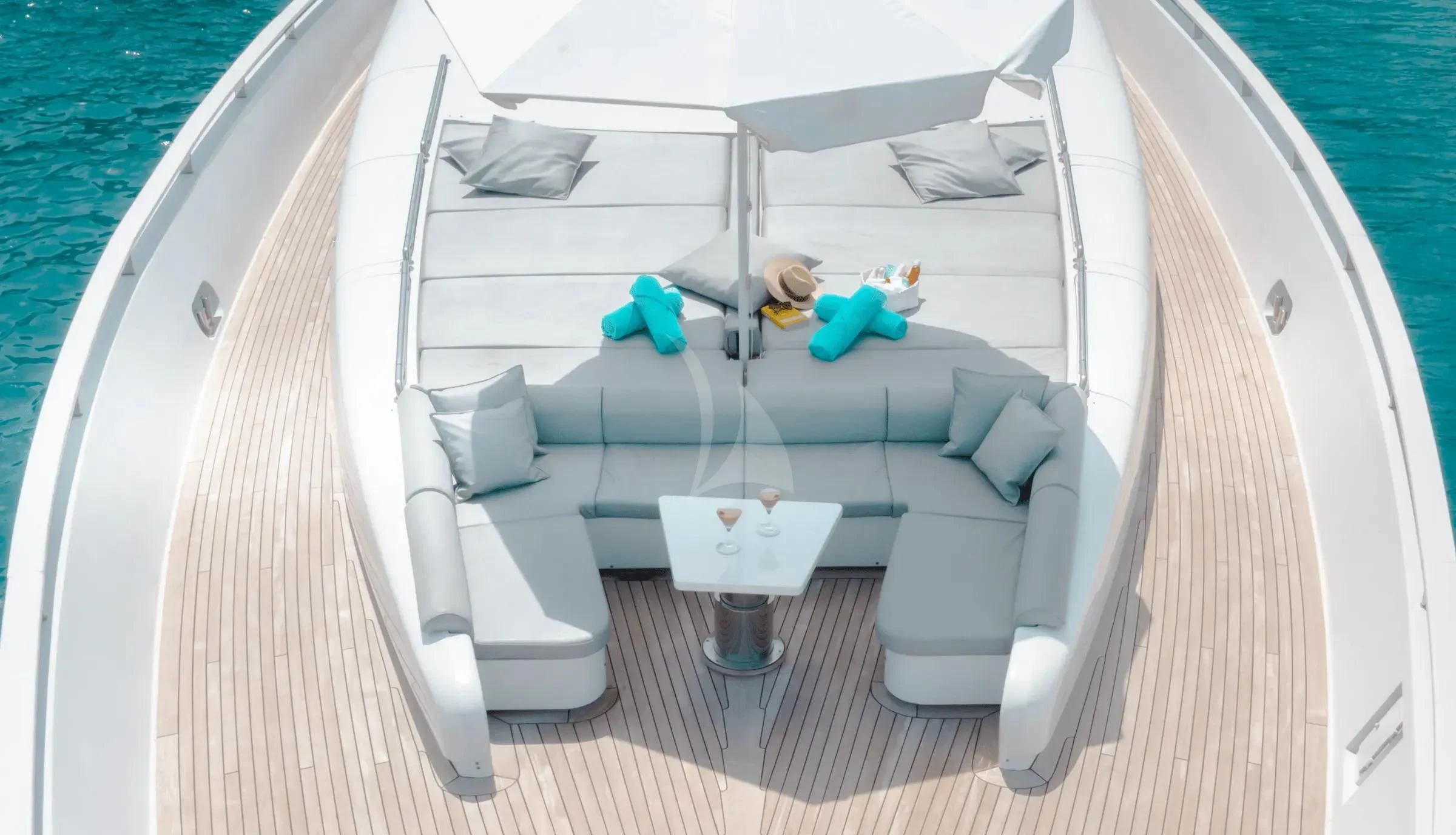 a white bed with blue pillows aboard MAC Yacht for Sale