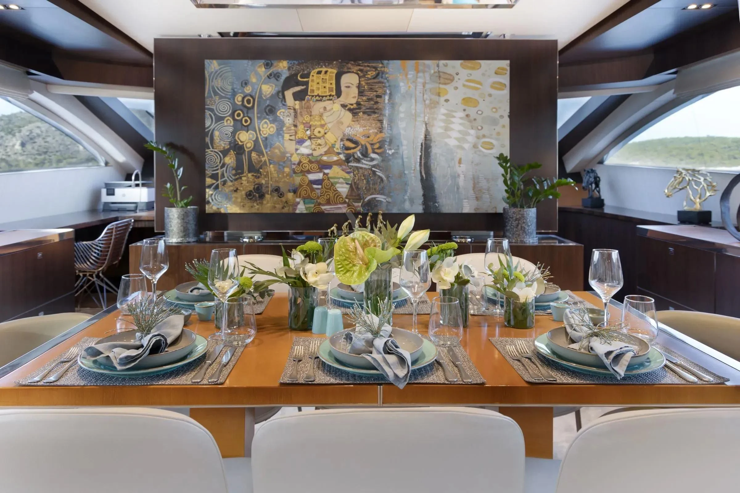 a table set with plates and glasses aboard MAC Yacht for Sale