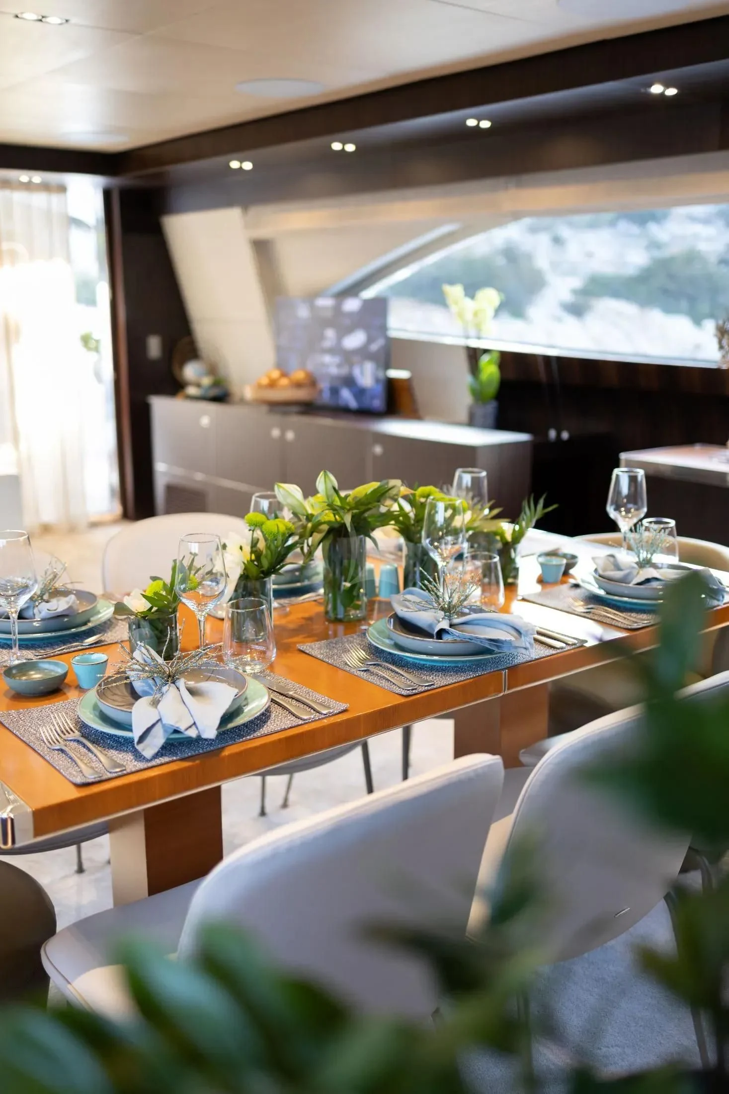 a table with plates and glasses aboard MAC Yacht for Sale