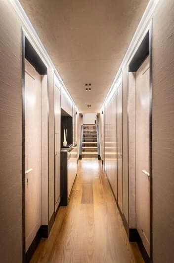 a long hallway with white walls aboard ALAIA Yacht for Sale