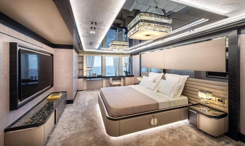 a large room with a bed and a tv aboard ALAIA Yacht for Sale
