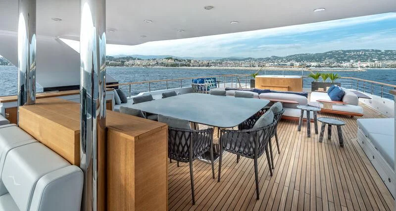a balcony with a table and chairs aboard ALAIA Yacht for Sale