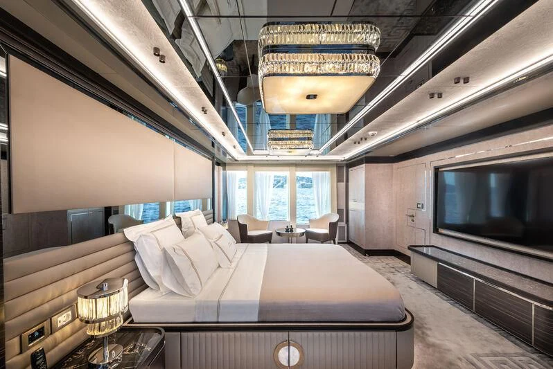 a room with a bed and a television aboard ALAIA Yacht for Sale