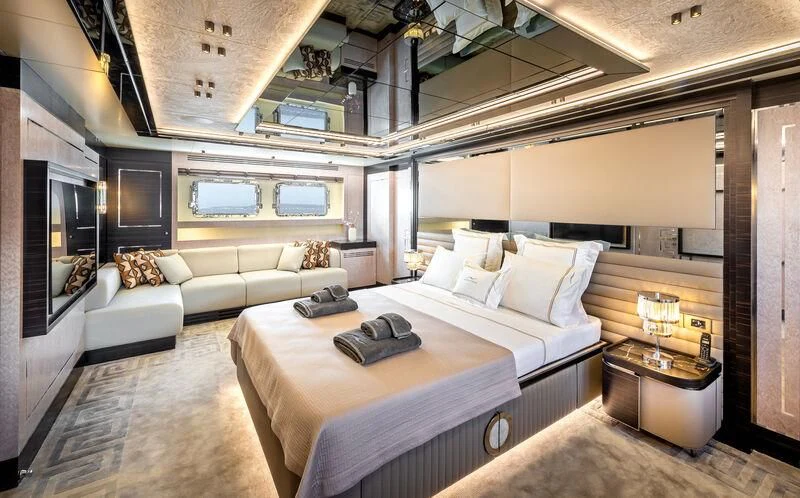 a room with a bed and a couch aboard ALAIA Yacht for Sale
