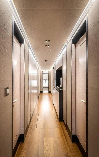 a long hallway with doors aboard ALAIA Yacht for Sale