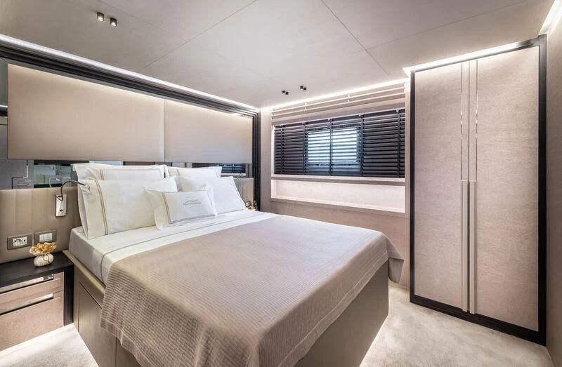 a bedroom with a bed and a window aboard ALAIA Yacht for Sale