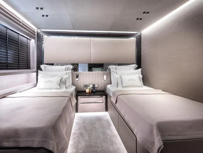 a room with beds and a window aboard ALAIA Yacht for Sale