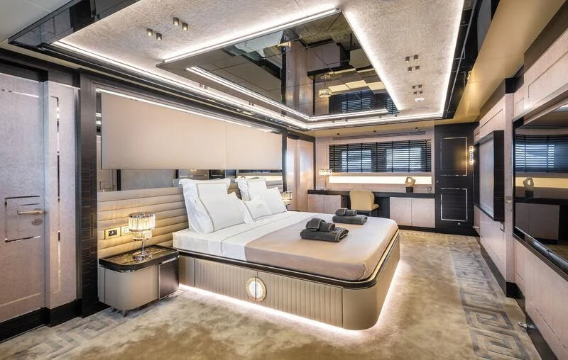 a room with a bed and a chair aboard ALAIA Yacht for Sale