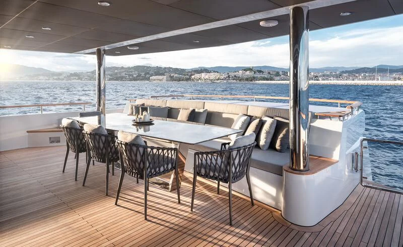a table and chairs on a deck aboard ALAIA Yacht for Sale