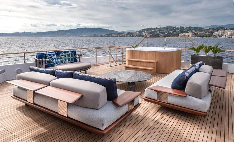 a room with a couch and a table and chairs aboard ALAIA Yacht for Sale