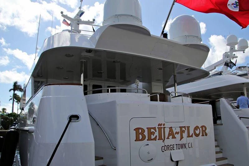 a white boat with a sign on it aboard CHANSON Yacht for Sale