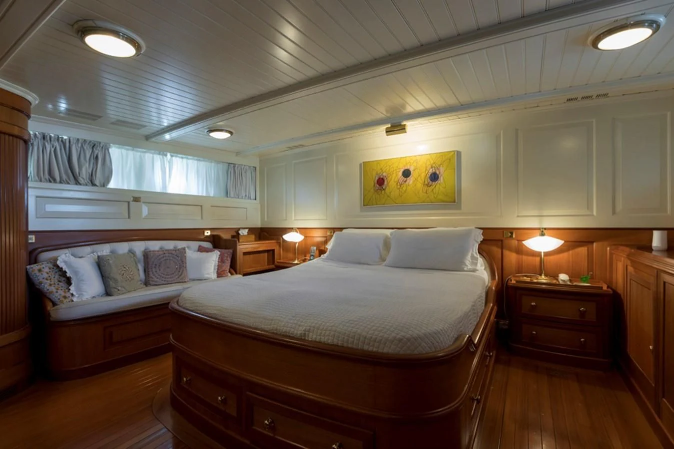 a bedroom with a bed and a dresser aboard LADY MAY OF GLANDORE Yacht for Sale