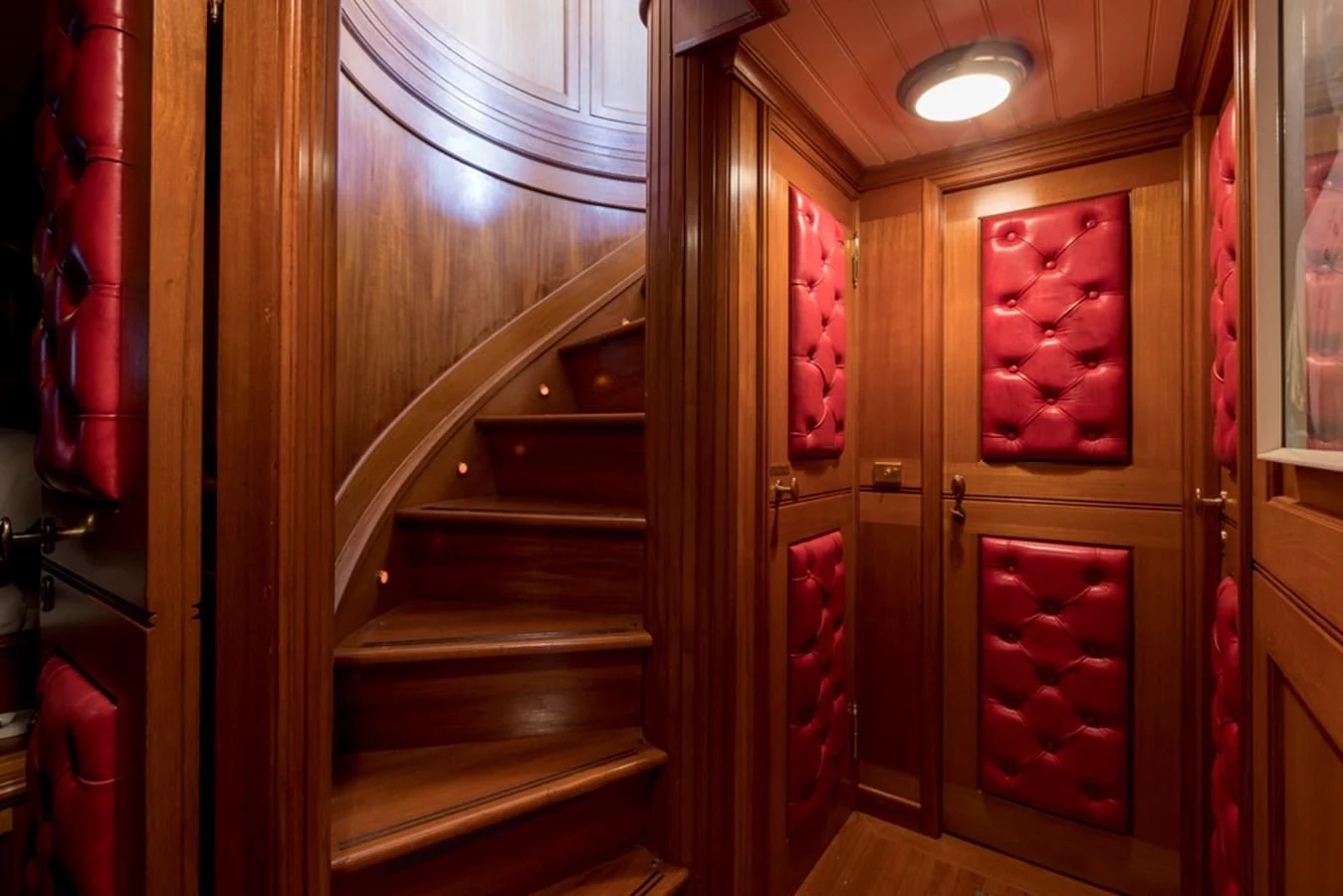 a room with a wood door and a red cabinet with a light aboard LADY MAY OF GLANDORE Yacht for Sale