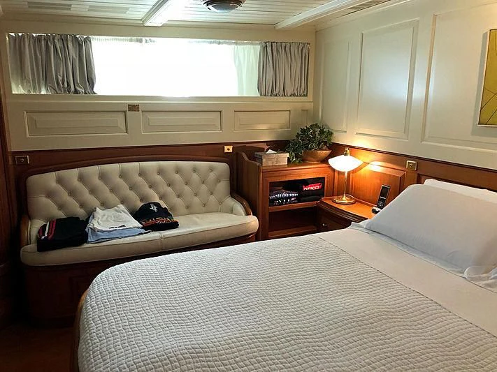 a hotel room with a bed and a couch aboard LADY MAY OF GLANDORE Yacht for Sale