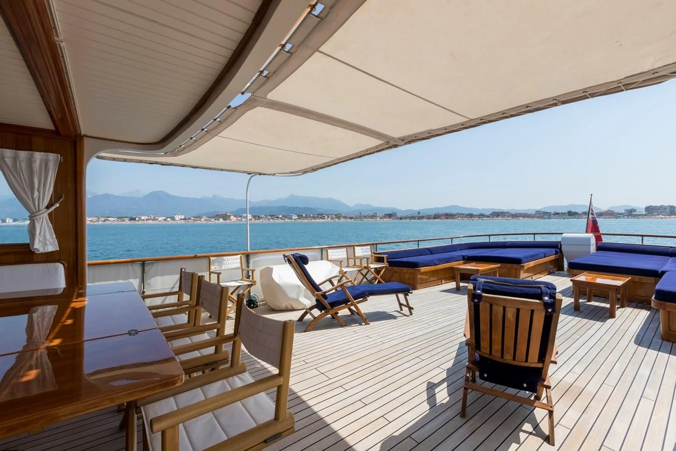 a deck with chairs and tables on it aboard LADY MAY OF GLANDORE Yacht for Sale