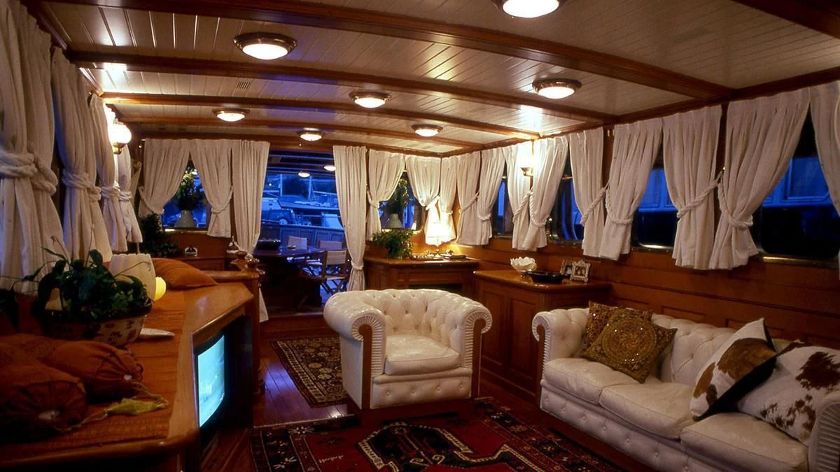 a room with a couch and a table and chairs aboard LADY MAY OF GLANDORE Yacht for Sale