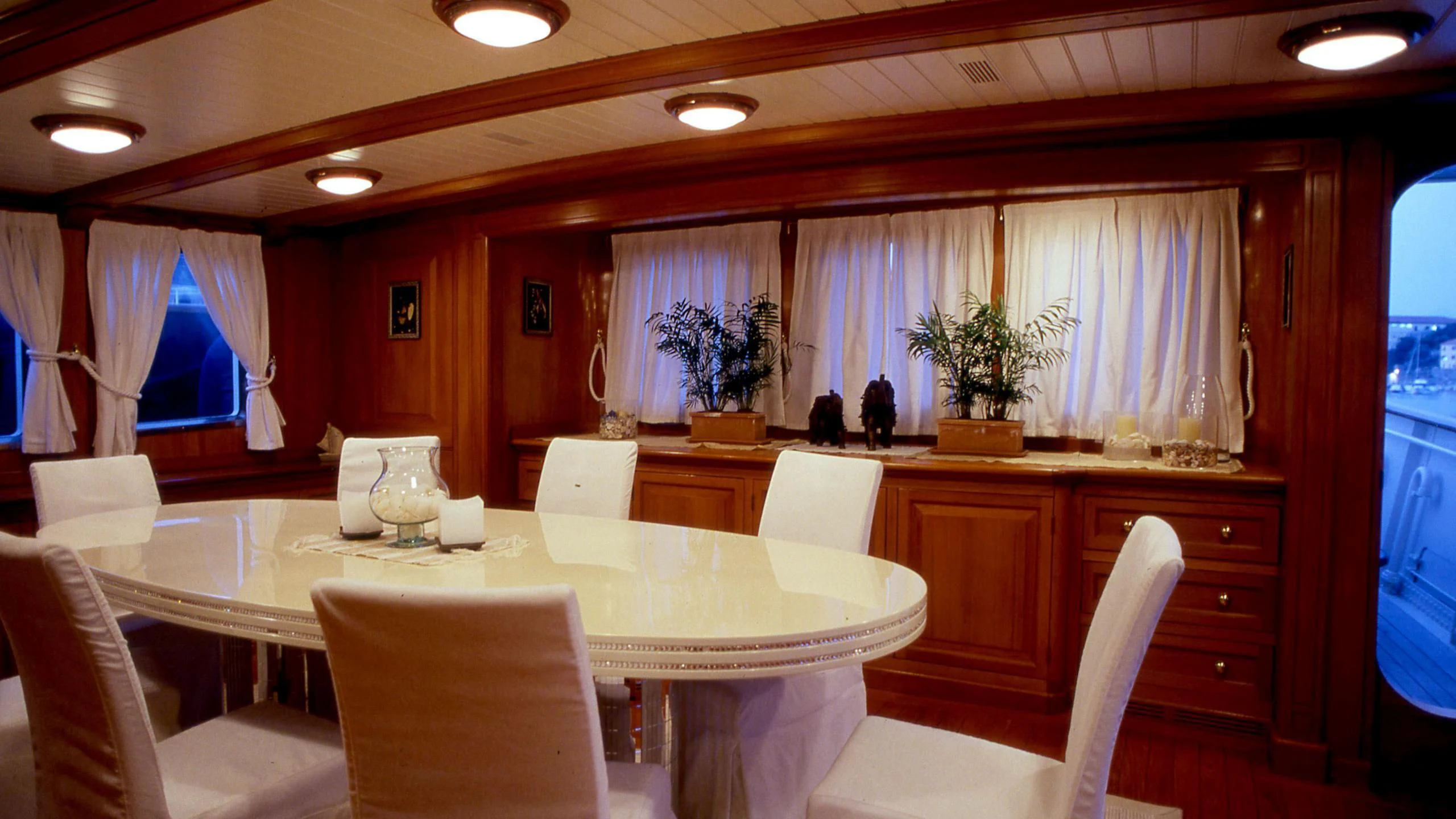 a large room with a table and chairs aboard LADY MAY OF GLANDORE Yacht for Sale