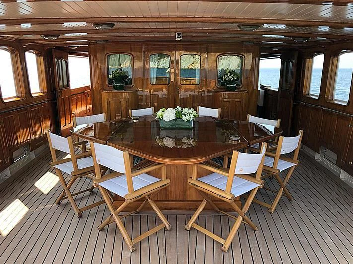 a dining table in a room aboard LADY MAY OF GLANDORE Yacht for Sale