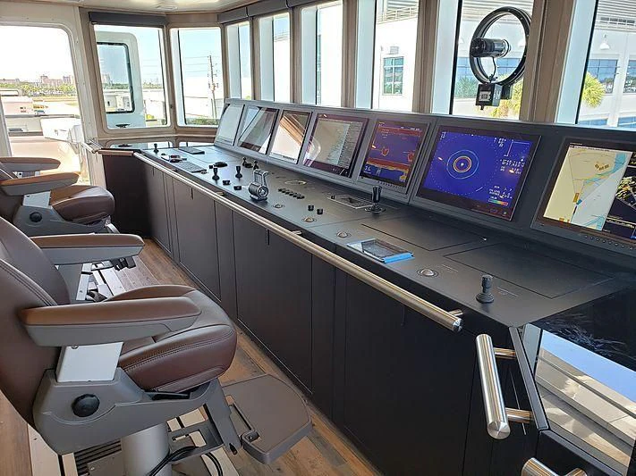 a room with many monitors and computers aboard VOYAGER Yacht for Sale