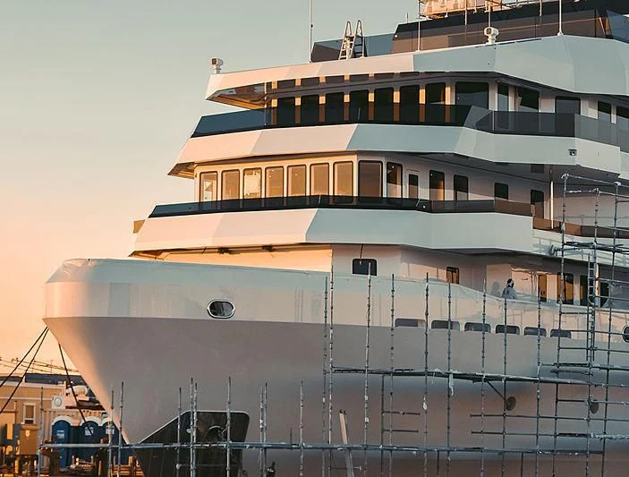 a large cruise ship docked aboard VOYAGER Yacht for Sale