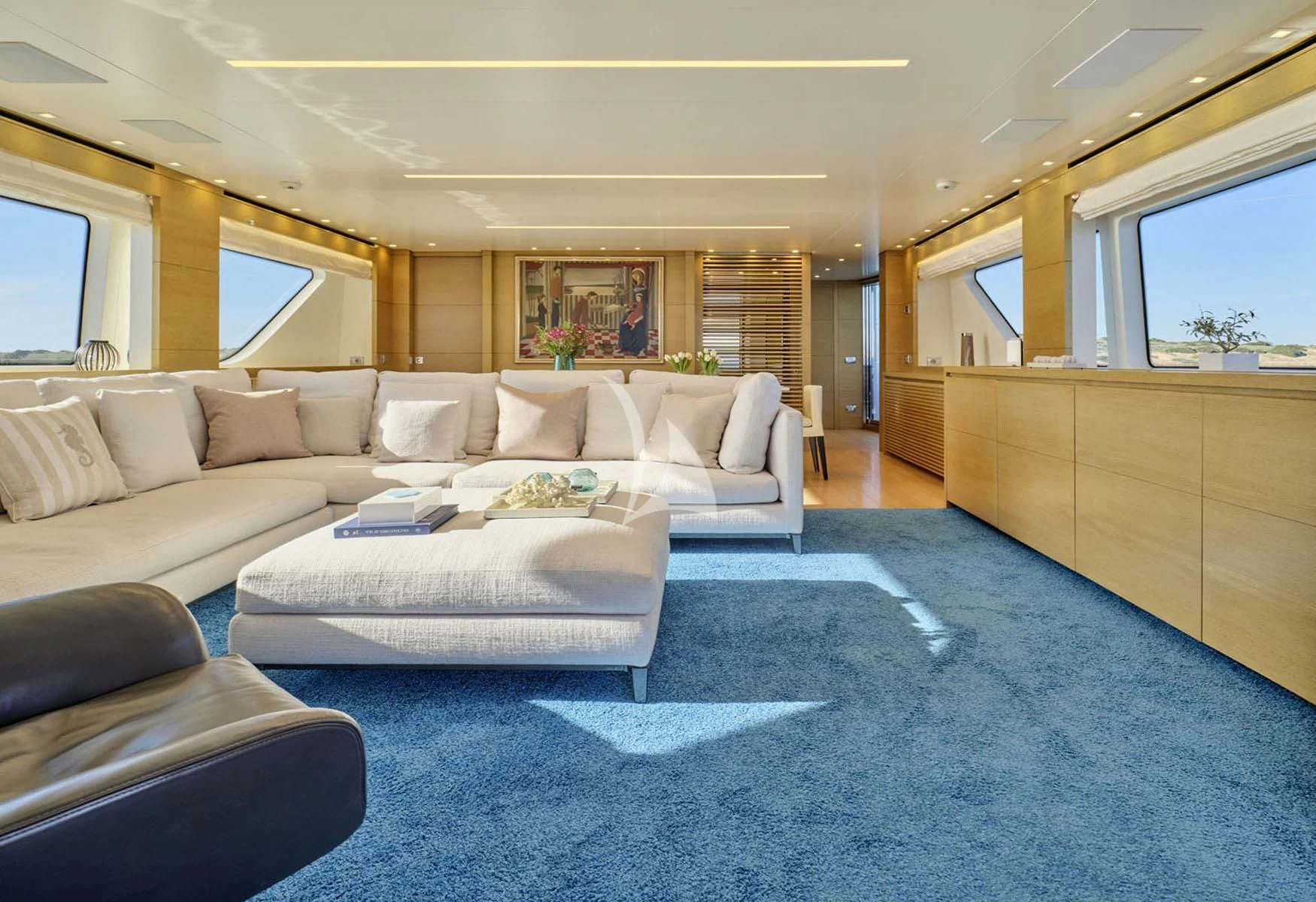 a living room with a couch and a table aboard FLOR Yacht for Charter
