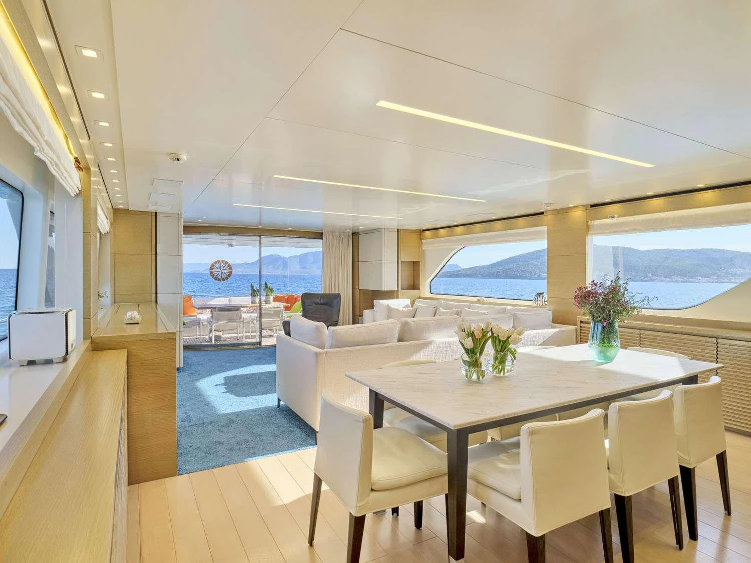 a dining table in a room aboard FLOR Yacht for Charter