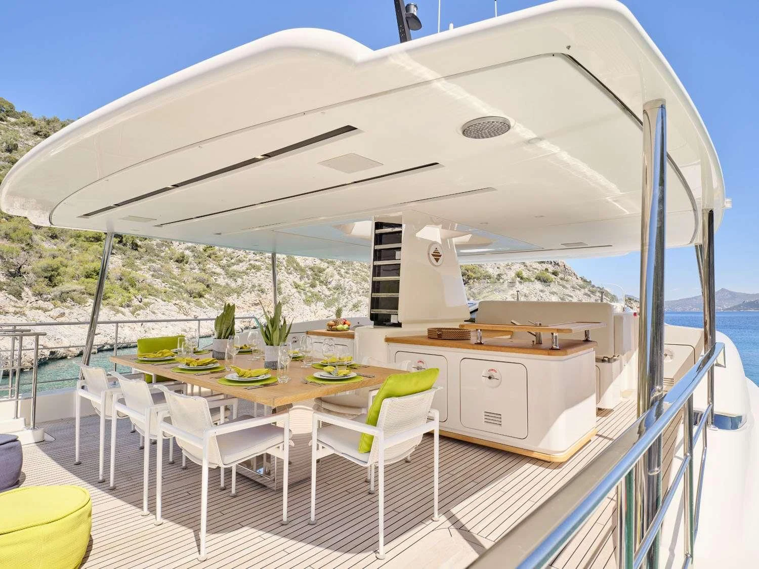 a deck with tables and chairs aboard FLOR Yacht for Charter