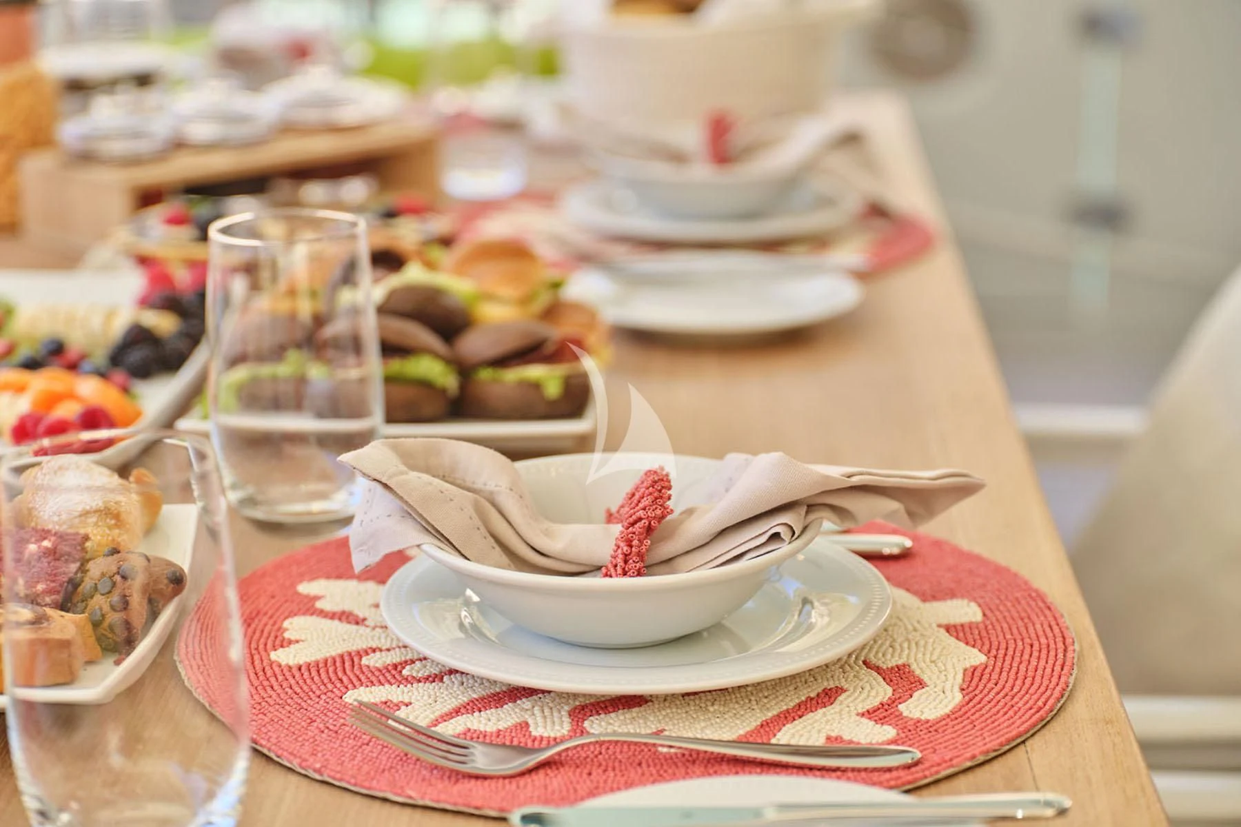 a table with plates and bowls of food on it aboard FLOR Yacht for Charter