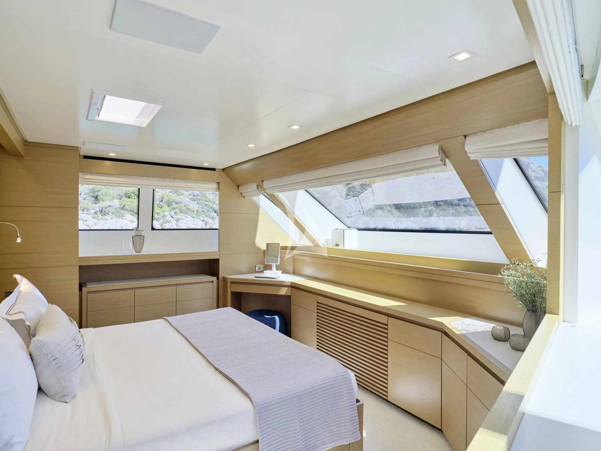 a room with a bed and a window aboard FLOR Yacht for Charter