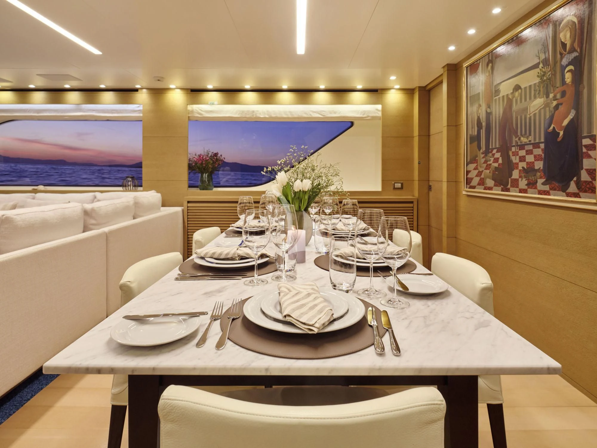 a table with plates and silverware aboard FLOR Yacht for Charter