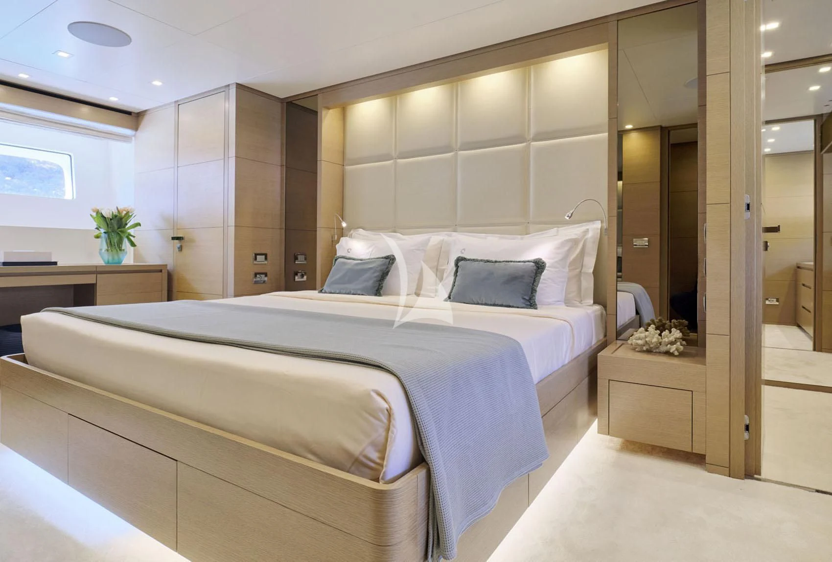 a large bedroom with a bed aboard FLOR Yacht for Charter