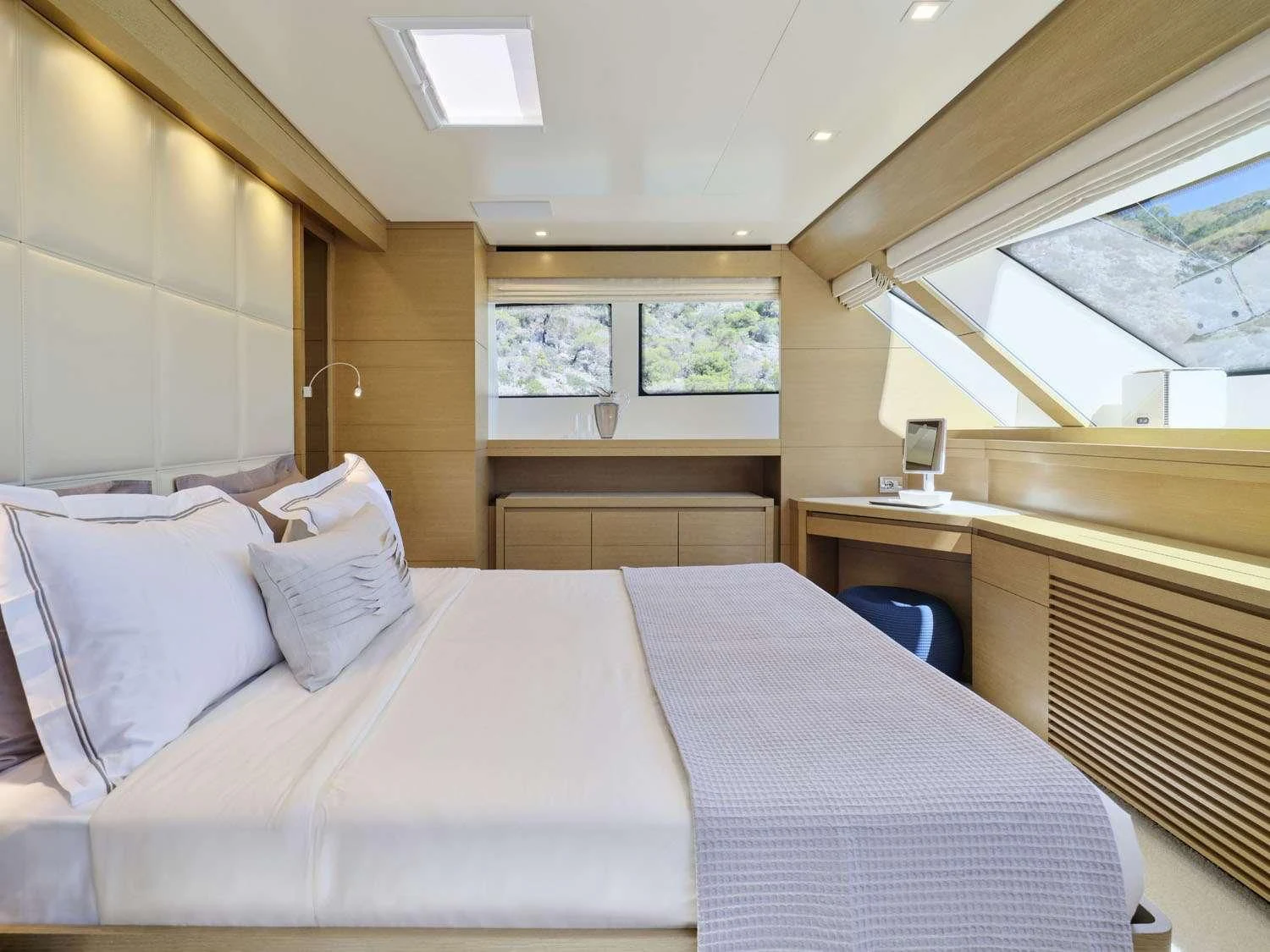 a room with a bed and a window aboard FLOR Yacht for Charter