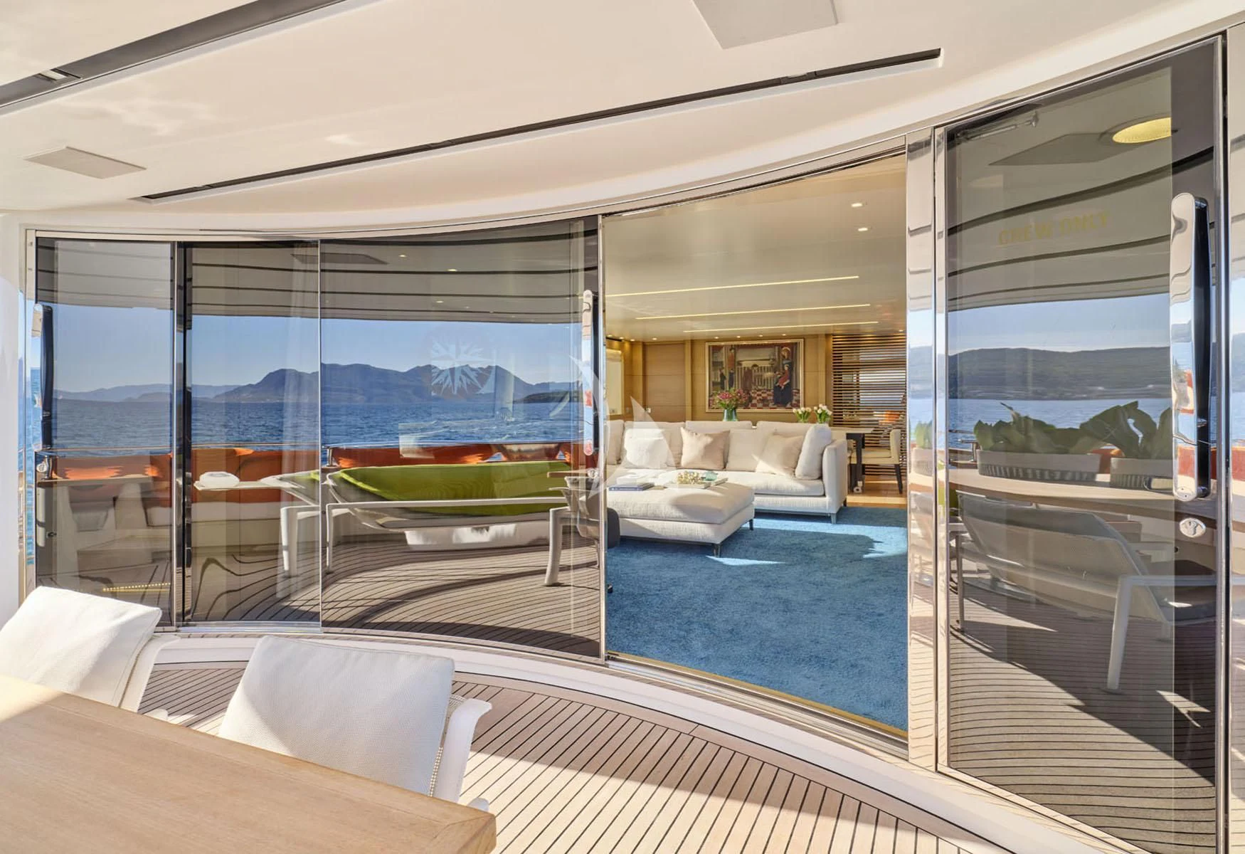 a living room with a large glass door aboard FLOR Yacht for Charter