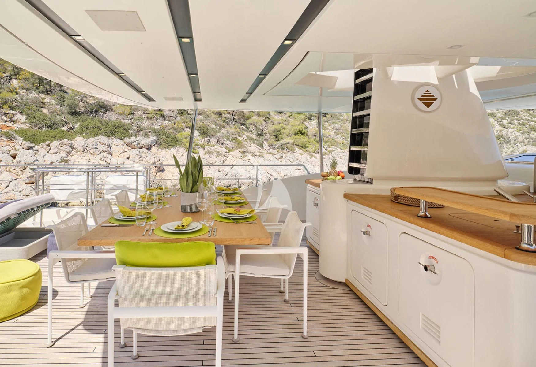 a table with chairs and a large window aboard FLOR Yacht for Charter