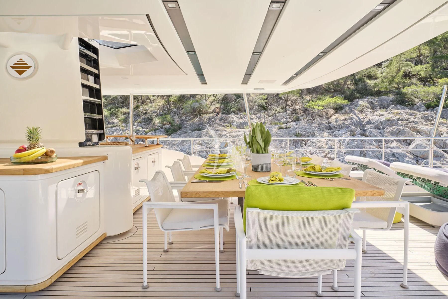 a table with chairs and a view of a city aboard FLOR Yacht for Charter