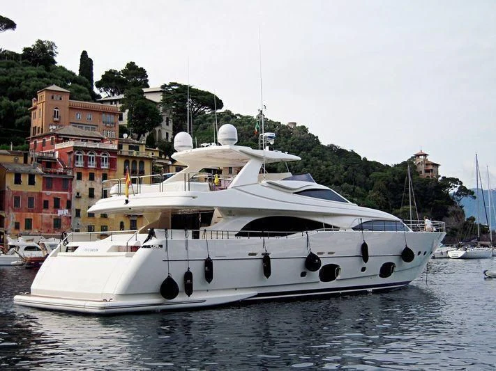 a white boat in a harbor aboard TIO CARLOS Yacht for Sale