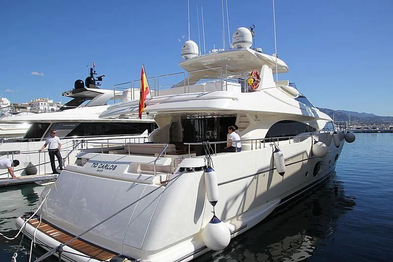 a boat with a flag on the front aboard TIO CARLOS Yacht for Sale