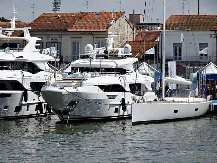 several white boats in a harbor aboard MY BAYA Yacht for Sale