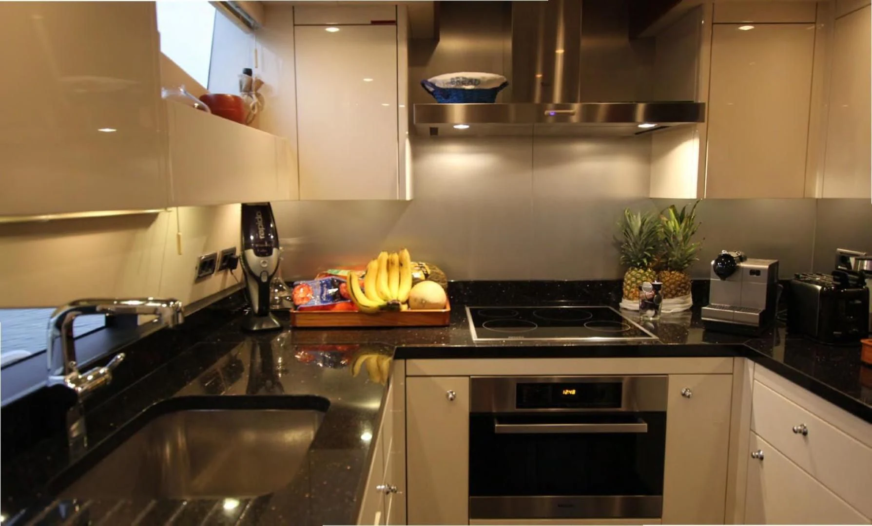 a kitchen with black counters aboard ABRAHAM M Yacht for Sale