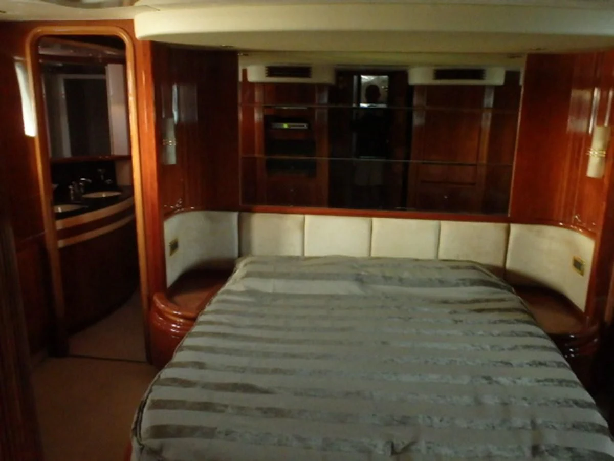 a room with a bed and a closet aboard FREE SPIRIT Yacht for Sale