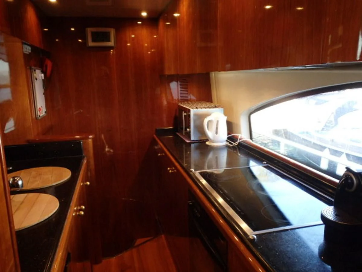 a kitchen with wooden cabinets aboard FREE SPIRIT Yacht for Sale