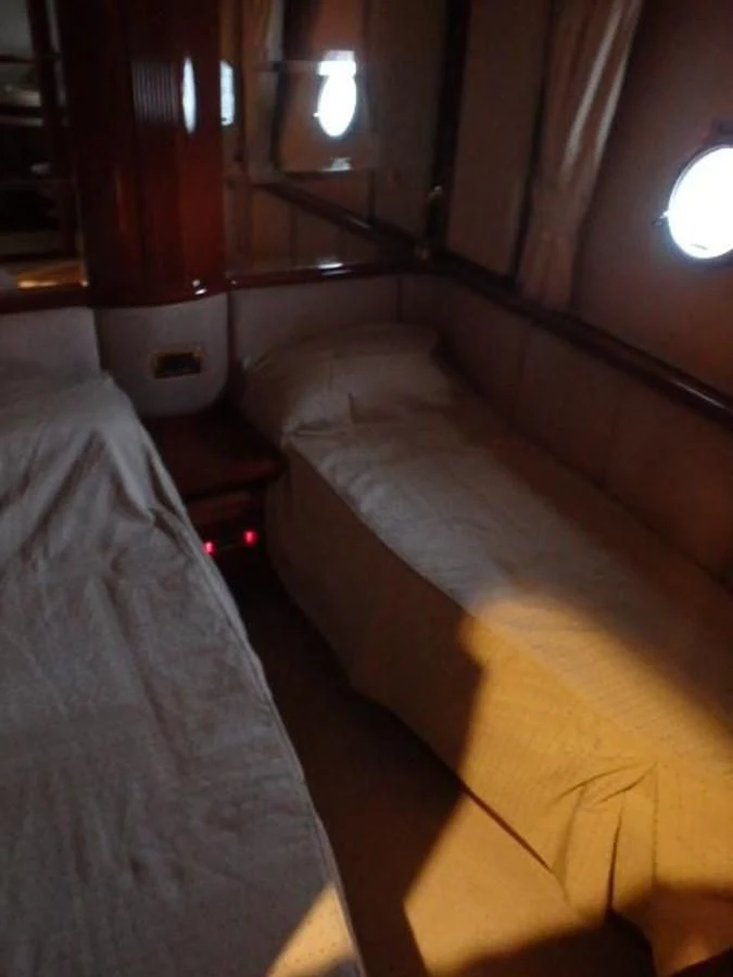 a bed with a light on it aboard FREE SPIRIT Yacht for Sale