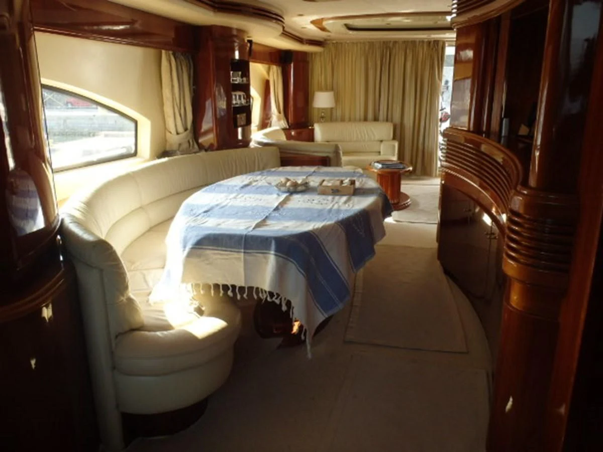 a room with a bed and chairs aboard FREE SPIRIT Yacht for Sale