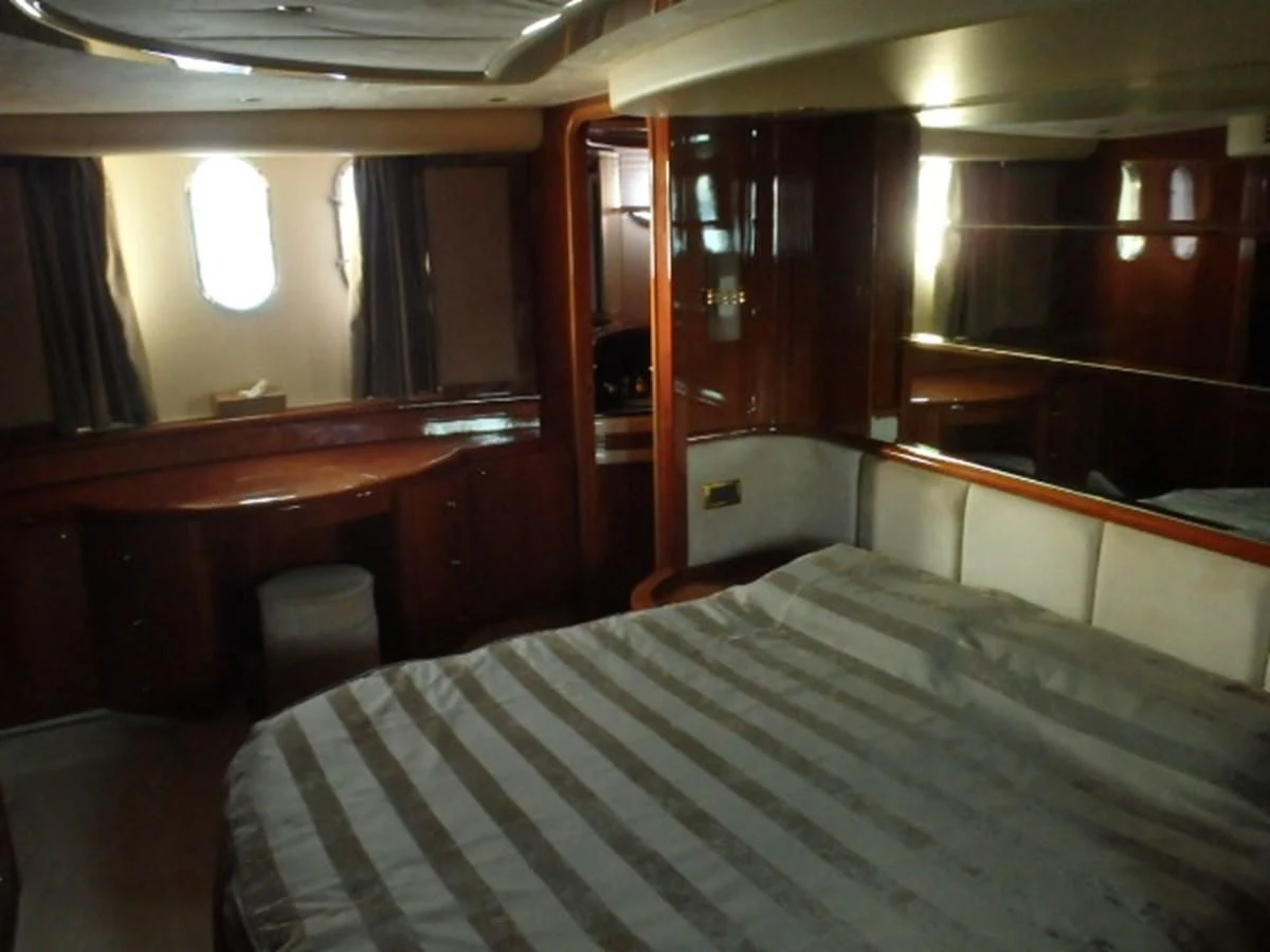 a room with a bed and desk aboard FREE SPIRIT Yacht for Sale