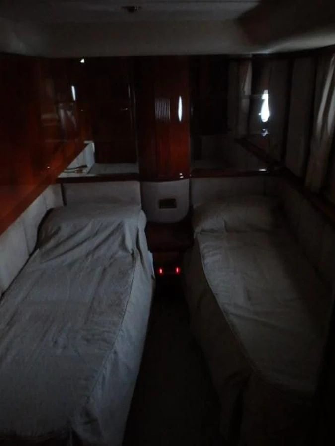 a room with beds and a red door aboard FREE SPIRIT Yacht for Sale