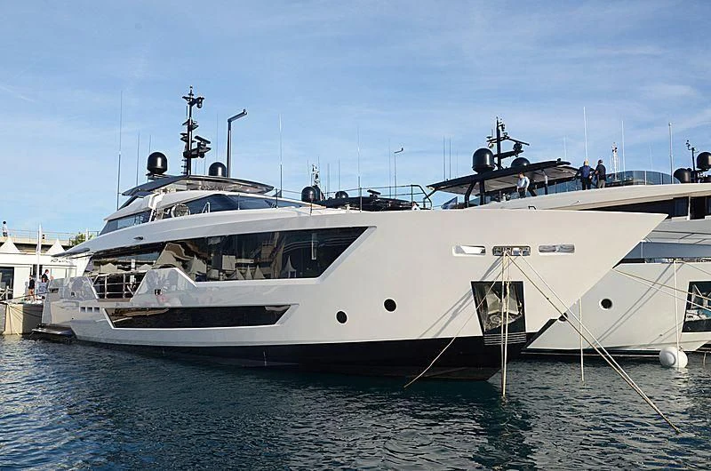 a white yacht docked at a pier aboard FUNNY Yacht for Sale