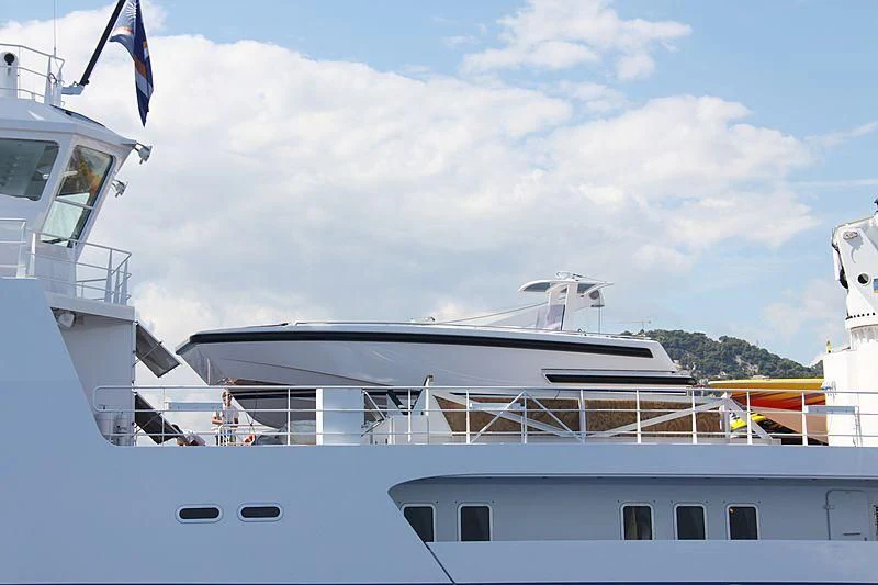 a boat with a flag on the deck aboard GARCON Yacht for Sale