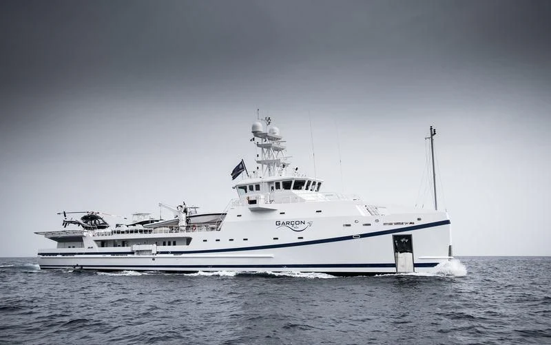 a large white ship in the water aboard GARCON Yacht for Sale